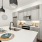 A modern kitchen featuring gray cabinets and stainless steel appliances